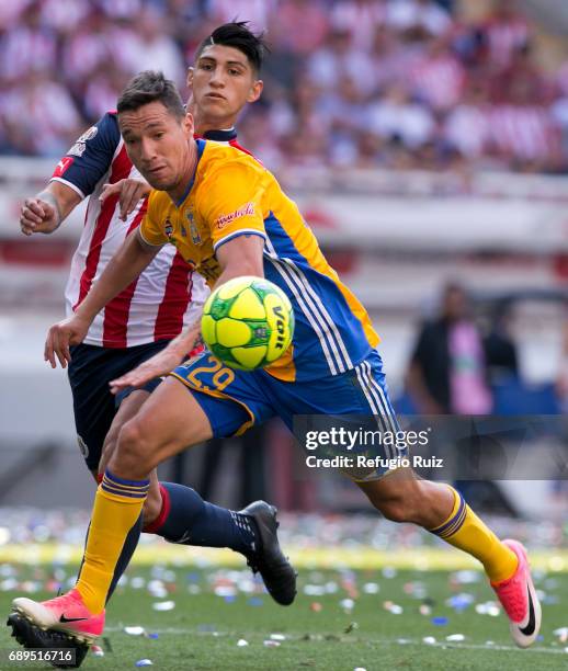 Alan Pulido of Chivas fights for the ball with Jesús Dueñas of Tigres during the Final second leg match between Chivas and Tigres UANL as part of the...