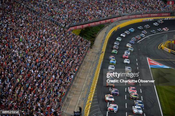 The field for the Coca-Cola 600 exits Turn 4 and heads down the front stretch at Charlotte Motor Speedway as fans cheer on Sunday, May 28, 2017.