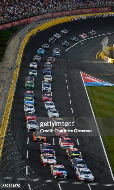 The field for the Coca-Cola 600 exits Turn 4 and heads down the front stretch at Charlotte Motor Speedway as fans cheer on Sunday, May 28, 2017.