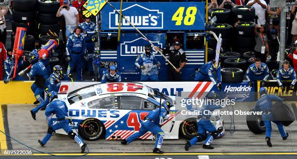 Driver Jimmie Johnson's pit crew rushes around the car, making adjustments during segment one of the Coca-Cola 600 at Charlotte Motor Speedway on...