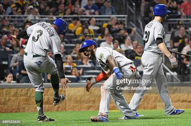 Jose Reyes of the New York Mets celebrates with Curtis Granderson after coming around to score on an RBI double by Jay Bruce in the fifth inning...