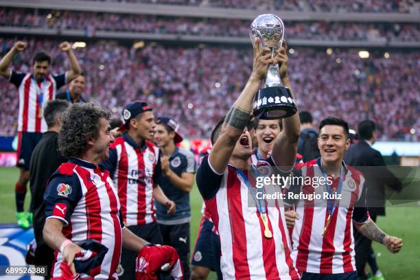 Alan Pulido of Chivas lifts the champions trophy after winning the Final second leg match between Chivas and Tigres UANL as part of the Torneo...