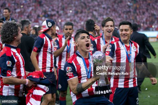 Alan Pulido of Chivas lifts the champions trophy after winning the Final second leg match between Chivas and Tigres UANL as part of the Torneo...