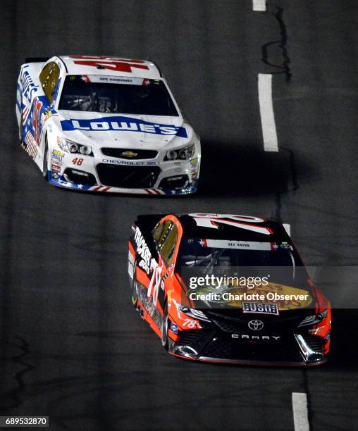 Driver Martin Truex Jr. Leads Jimmie Johnson down the front stretch of Charlotte Motor Speedway during the second segment of the Coca-Cola 600 on...