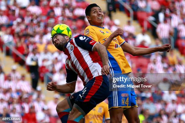 Jair Pereira of Chivas fights for the ball with Hugo Ayala of Tigres during the Final second leg match between Chivas and Tigres UANL as part of the...