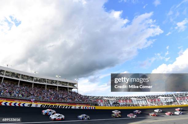 Kevin Harvick, driver of the Mobil 1 Ford, and Kyle Busch, driver of the M&M's Red, White, & Blue Toyota, lead the field to green for the Monster...