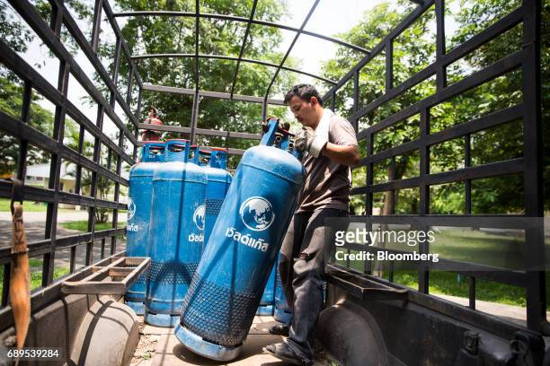 Worker moves a gas canisters on a truck outside the Nithi Foods Co. Factory in the San Pa Tong district of Chiang Mai, Thailand, on Tuesday, May 23,...