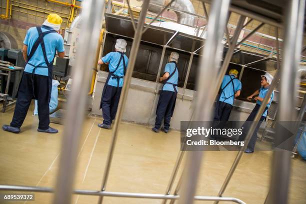 Workers process dehydrated garlic at the Nithi Foods Co. Factory in the San Pa Tong district of Chiang Mai, Thailand, on Tuesday, May 23, 2017....