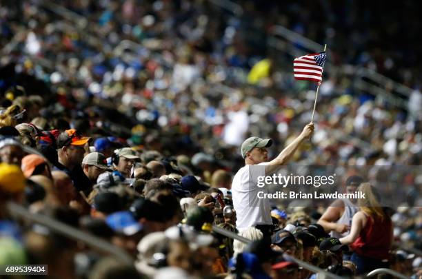 Fan holds a flag during the Monster Energy NASCAR Cup Series Coca-Cola 600 at Charlotte Motor Speedway on May 28, 2017 in Charlotte, North Carolina.