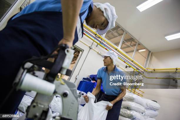 Employees seal and stack bags of garlic at the Nithi Foods Co. Factory in the San Pa Tong district of Chiang Mai, Thailand, on Tuesday, May 23, 2017....