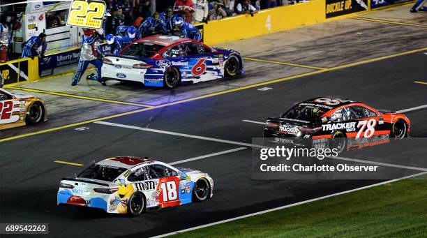 Driver Martin Truex Jr. Leads the field off pit road at Charlotte Motor Speedway during the second segment of the Coca-Cola 600 on Sunday, May 28,...