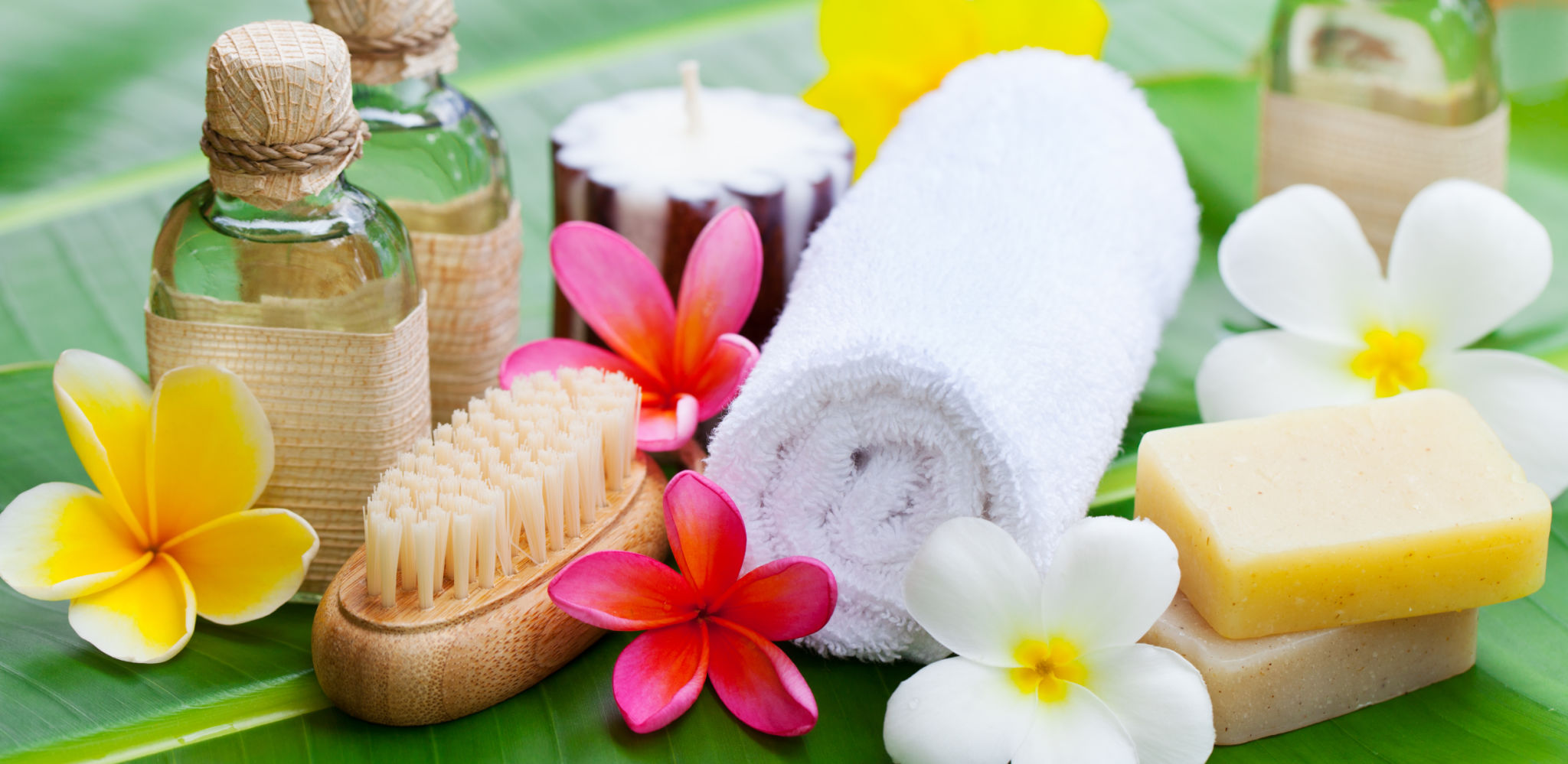 Spa, wellness setting with flowers on a palm leaf Spa, wellness setting with flowers on a palm leaf