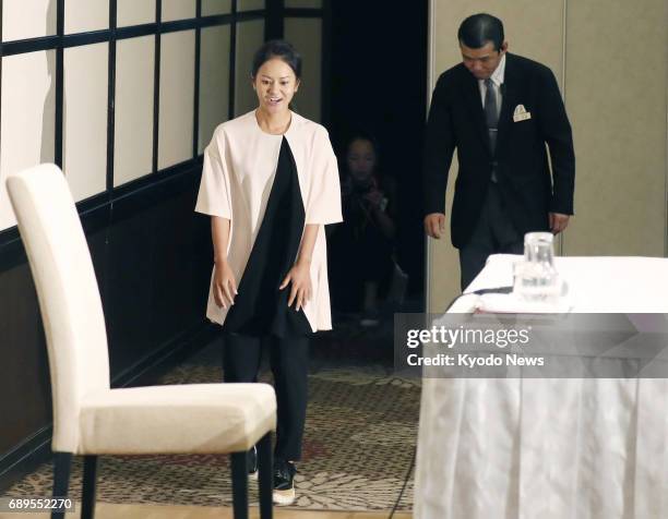 Former women's world No. 1 golfer Ai Miyazato arrives at the venue for a press conference in Tokyo on May 29 to formally announce her decision to...