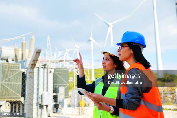 female workers in a wind turbines farm - wind power plant stock pictures, royalty-free photos & images