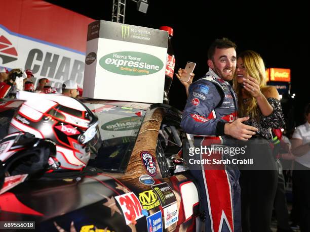 Austin Dillon, driver of the DOW Salutes Veterans Chevrolet, celebrates with his girlfriend, Whitney Ward, after winning the Monster Energy NASCAR...