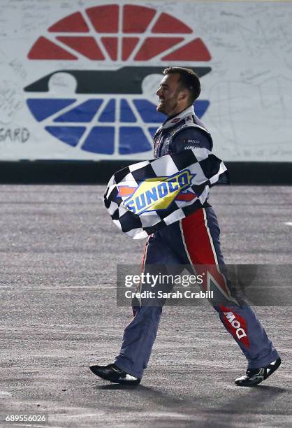 Austin Dillon, driver of the DOW Salutes Veterans Chevrolet, celebrates with the checkered flag during the Monster Energy NASCAR Cup Series Coca-Cola...