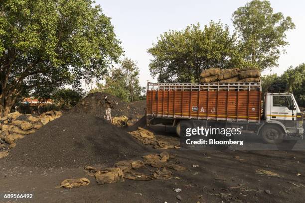 Truck transporting sacks of coal sit parked at a wholesale supplier's in New Delhi, India, on Sunday, May 28, 2017. India's ailing electricity...