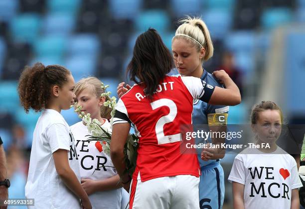 Steph Houghton of Manchester City Women and Alex Scott of Arsenal Ladies embrace before kick off during the WSL 1 match between Manchester City...