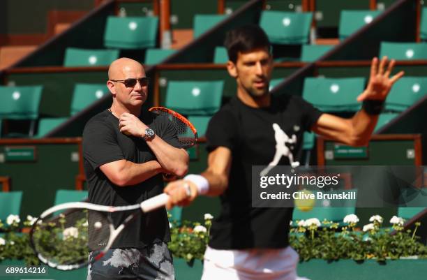 Coach Andre Agassi watches on during a Novak Djokovic training session prior to his match against Marcel Granollers of Spain on day two of the 2017...