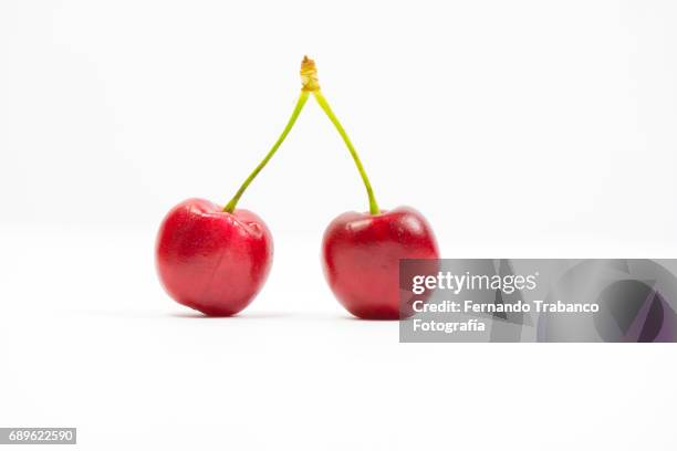 two sweet and tasty cherries on white background - cherry on the cake stock pictures, royalty-free photos & images
