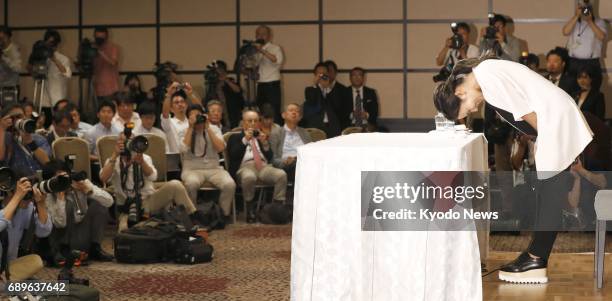 Former women's world No. 1 golfer Ai Miyazato bows at the end of a press conference in Tokyo on May 29 held to formally announce her decision to...
