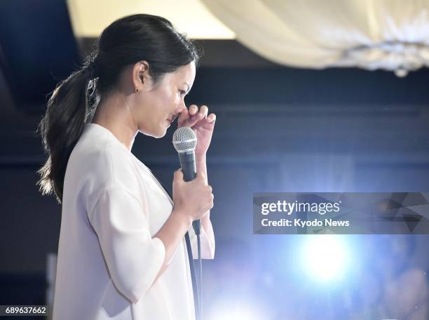 Former women's world No. 1 golfer Ai Miyazato is moved to tears while announcing her decision to retire during a press conference in Tokyo on May 29,...