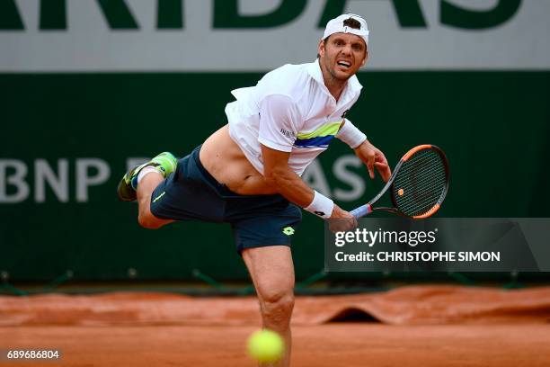 France's Paul-Henri Mathieu serves the ball to Belgium's David Goffin during their tennis match at the Roland Garros 2017 French Open on May 29, 2017...