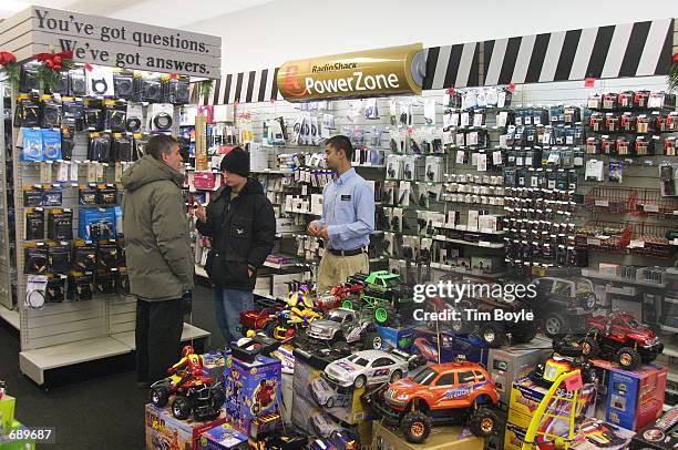 Sales associate Raheel Hameed assists customers at a Radio Shack store January 3, 2002 in Skokie, IL. The Fort Worth, Texas-based Radio Shack, one of...