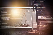 Justice weight scales with code on monitor in background