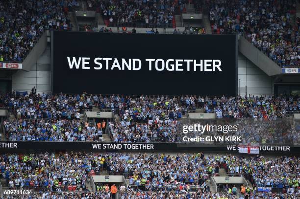 Supporters applaud in the 22nd minute of the game for the victims of the Manchester bombing during the English Championship play-off final football...