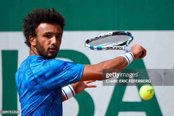 France's Maxime Hamou returns the ball to Uruguay's Pablo Cuevas during their tennis match at the Roland Garros 2017 French Open on May 29, 2017 in...