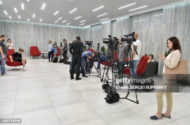 Journalists wait in a hall of the Leonardo Business Centre in Kiev on May 29 during searches at the Yandex internet company by Kiev security...