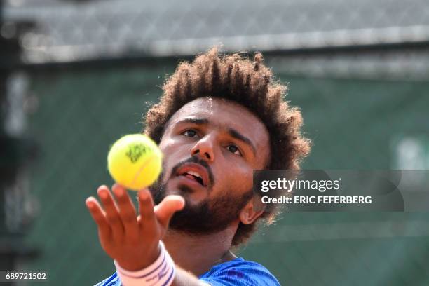 France's Maxime Hamou serves the ball to Uruguay's Pablo Cuevas during their tennis match at the Roland Garros 2017 French Open on May 29, 2017 in...