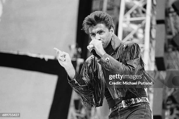 British singer-songwriter George Michael of Wham! performing at the pop duos farewell concert, entitled 'The Final', at Wembley Stadium, London,...