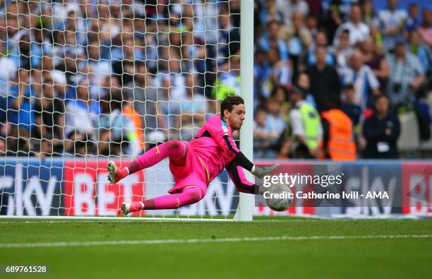 Goalkeeper Danny Ward of Huddersfield Town saves a penalty during the shootout during the Sky Bet Championship Play Off Final match between Reading...