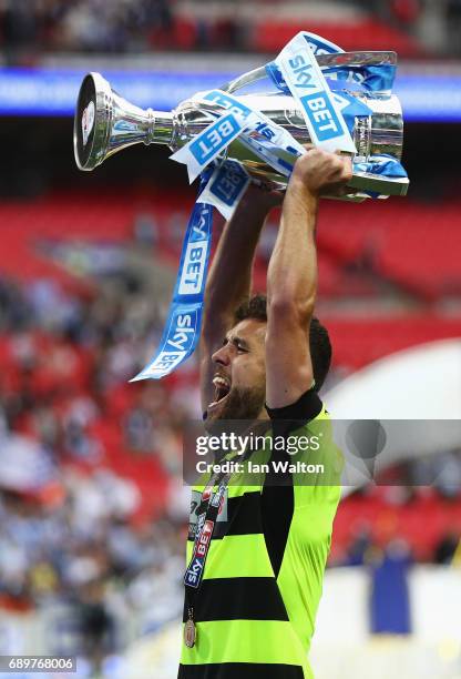 Tommy Smith of Huddersfield Town celebrates with The Championship play off trophy after the Sky Bet Championship play off final between Huddersfield...