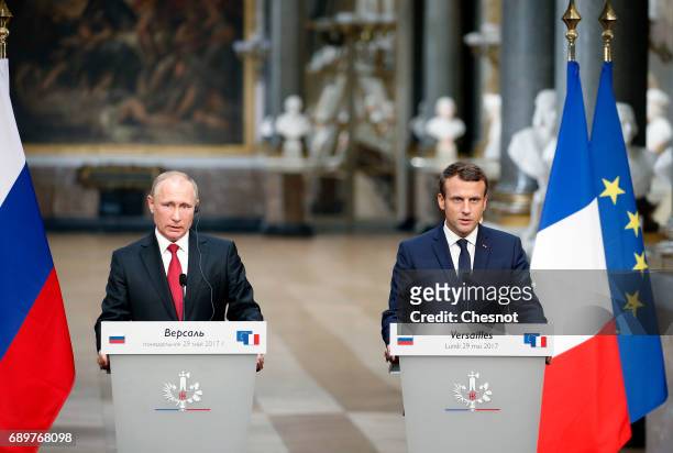 Russian President Vladimir Putin and French President Emmanuel Macron hold a joint press conference at "Chateau de Versailles" on May 29, 2017 in...
