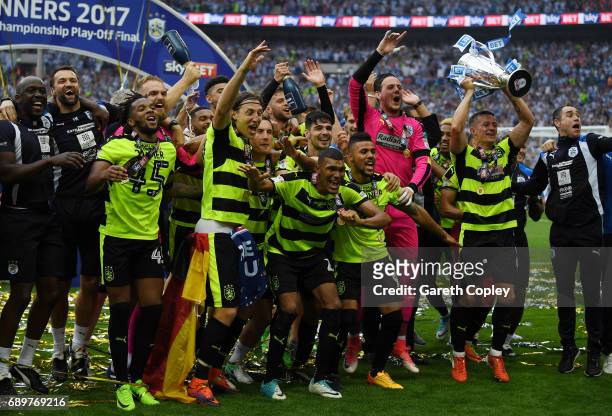 The Huddersield Town team celebrate with The Championship play off trophy after the Sky Bet Championship play off final between Huddersfield and...