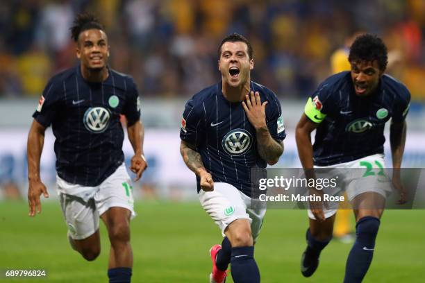 Vieirinha of Wolfsburg celebrates his team's first goal with team mates during the Bundesliga Playoff leg 2 match between Eintracht Braunschweig and...