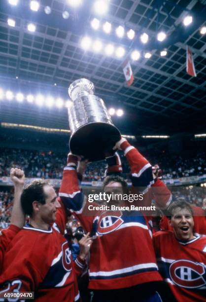 Larry Robinson, Bob Gainey and Mats Naslund of the Montreal Candiens celebrate with the Stanley Cup Trophy after defeating the Calgary Flames in Game...