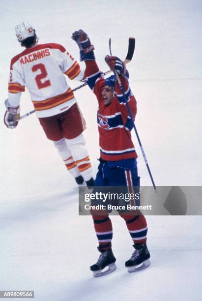 Chris Chelios of the Montreal Canadiens celebrates on the ice as Al MacInnis of the Calgary Flames skates away dejected during a game in the 1986...