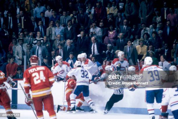 Claude Lemieux of the Montreal Canadiens hits John Tonelli of the Calgary Flames during a game in the 1986 Stanley Cup Finals circa May, 1986 at the...