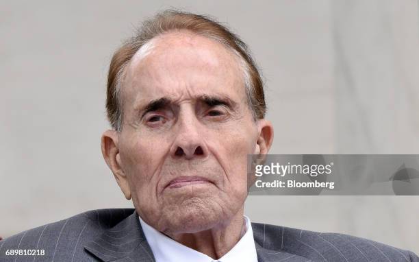 Former Senator Bob Dole listens as U.S. President Donald Trump, not pictured, speaks at a wreath laying ceremony at the Tomb of the Unknown Soldier...