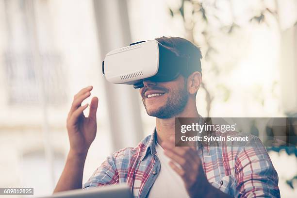 entrepreneur testing virtual reality technology - virtualitytrend stock pictures, royalty-free photos & images