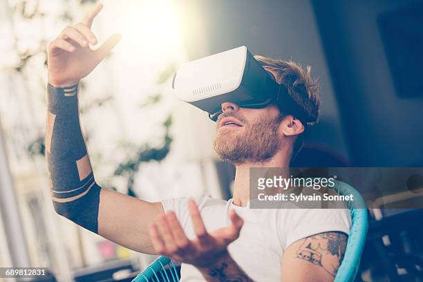 entrepreneur testing virtual reality technology - virtualitytrend stock pictures, royalty-free photos & images
