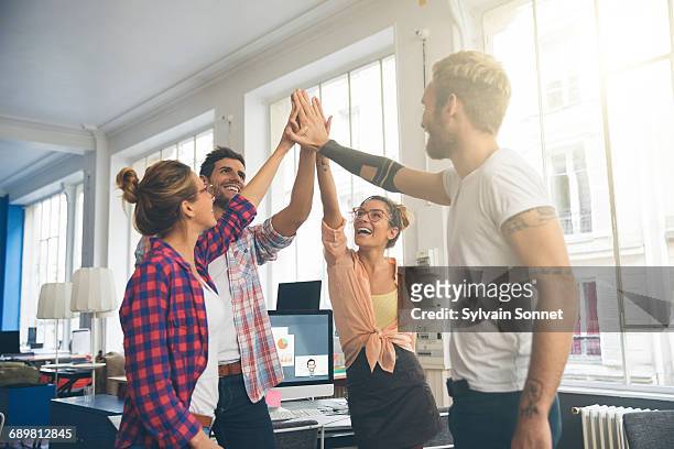 young business entrepreneurs celebrating a success - the paris agreement stock pictures, royalty-free photos & images