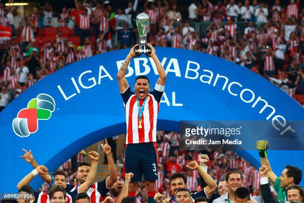Carlos Salcido of Chivas lifts the champions trophy after winning the Final second leg match between Chivas and Tigres UANL as part of the Torneo...