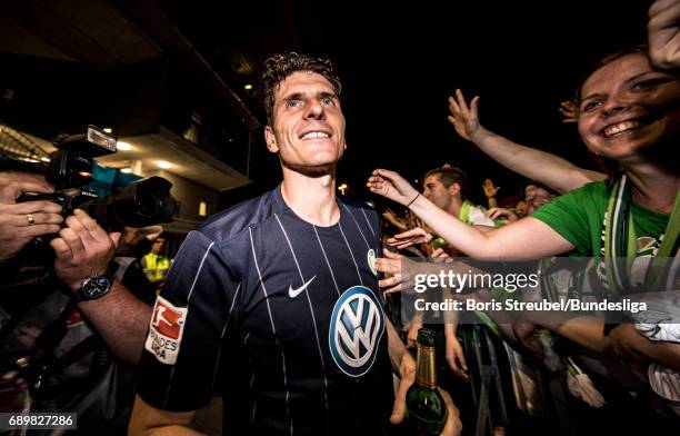 Mario Gomez of VfL Wolfsburg celebrates with the fans the continuance in the first Bundesliga after winning the Bundesliga Playoff Leg 2 match...