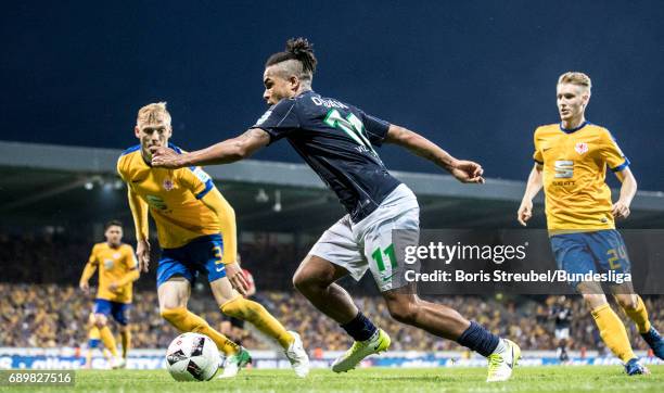 Daniel Didavi of VfL Wolfsburg is challenged by Saulo Decarli and Maximilian Sauer of Eintracht Brauschweig during the Bundesliga Playoff Leg 2 match...