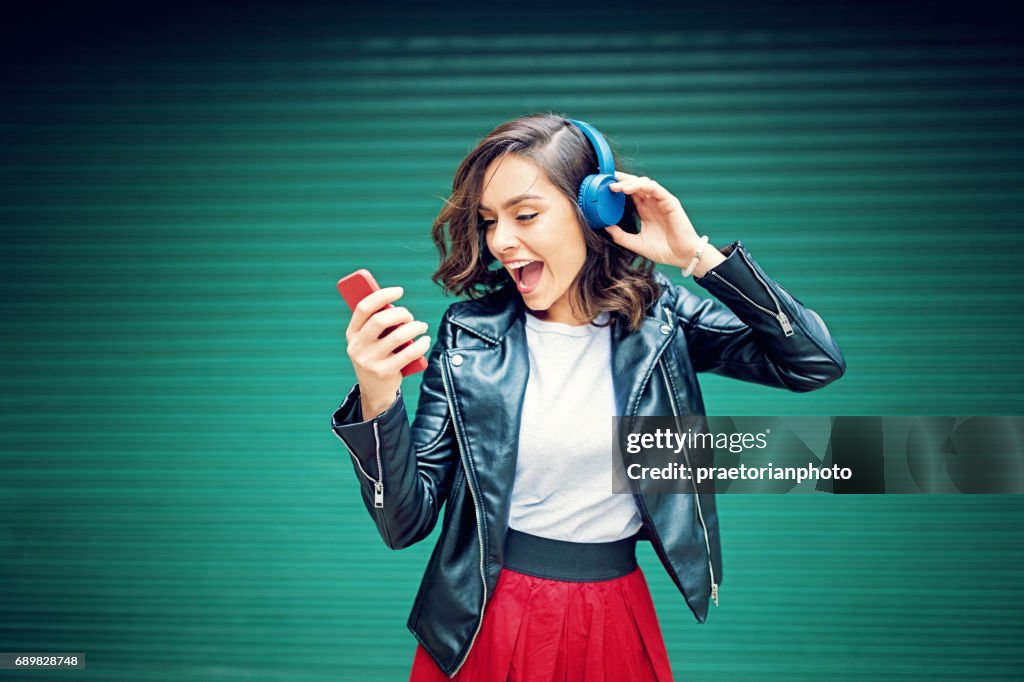Young girl is dancing and listening the music